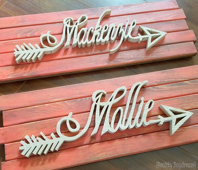 Custom-Wooden-Arrow-Name-Plaques-affixed-to-barn-wood